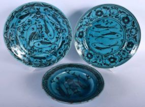 THREE PERSIAN MIDDLE EASTERN BLUE GLAZED DISHES. Largest 23 cm diameter. (3)