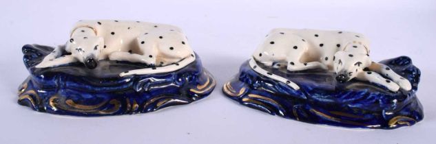 A SMALL PAIR OF 19TH CENTURY STAFFORDSHIRE FIGURES OF DALMATIONS. 9.5 cm wide.