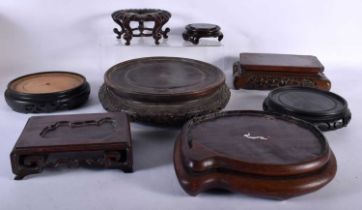 A LARGE COLLECTION OF 19TH/20TH CENTURY CHINESE HARDWOOD STANDS Qing. Largest 24 cm diameter. (qty)