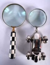TWO NOVELTY MAGNIFYING GLASSES one formed as a checkerboard, the other a race car. 22 cm long. (2)