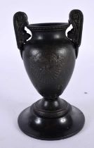 A 19TH CENTURY EUROPEAN TWIN HANDLED GRAND TOUR BRONZE URN After the Antiquity, decorative with bold