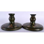 A PAIR OF 19TH CENTURY PERSIAN QAJAR LACQUER WOOD CANDLESTICKS of squat form. 14.5 cm wide.