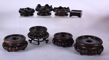 EIGHT CHINESE QING DYNASTY CARVED HARDWOOD DISPLAY STANDS. Largest 10.5 cm diameter. (8)