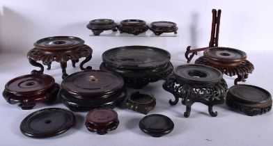 A LARGE COLLECTION OF 19TH/20TH CENTURY CHINESE HARDWOOD STANDS Qing. Largest 19 cm diameter. (qty)