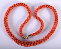 A Gold Mounted Coral Necklace with a Multi Bead Strand. Indistinct marks on gold. 52cm long,