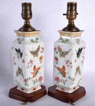 A PAIR OF EARLY 20TH CENTURY CHINESE FAMILLE ROSE PORCELAIN LAMPS Guangxu, painted with butterflies.