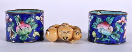 A PAIR OF 19TH CENTURY CHINESE CANTON ENAMEL NAPKIN RINGS together with a carved nut netsuke. 54.8