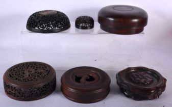 SIX CHINESE QING DYNASTY CARVED HARDWOOD LIDS. Largest 13 cm diameter. (6)