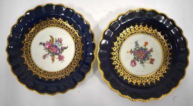 18th century Worcester fine pair of plates painted with flowers surrounded by elaborate gilding