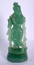 A RARE 19TH CENTURY INDIAN CARVED JADE FIGURE OF A FEMALE DEITY modelled playing a pipe. 17 cm