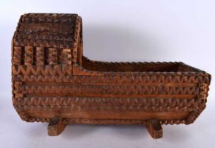 A VERY UNUSUAL TRAMP ART CARVED WOOD MODEL OF A CRIB. 42 cm x 30cm.