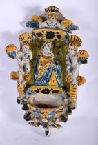 AN UNUSUAL 18TH CENTURY CONTINENTAL FAIENCE DELFT TWIN GLAZED FONT modelled with a saint beside