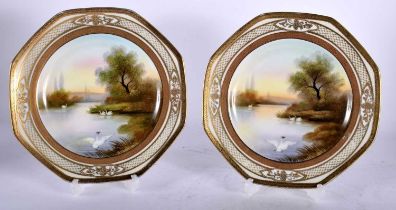 A PAIR OF JAPANESE NORITAKE PORCELAIN OCTAGONAL PLATES painted with swans in a lake. 20 cm wide.