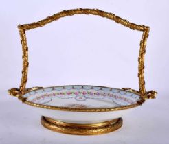 A 19TH CENTURY FRENCH SEVRES PORCELAIN BASKET mounted in French bronze, formed with ribbons. 23 cm x