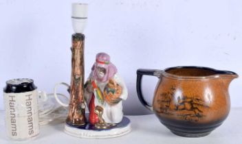An antique Arthur Woods hunting themed jug together with a Continental porcelain snake charmer