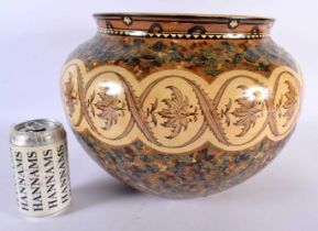 A LARGE ARTS AND CRAFTS MINTON POTTERY JARDINIERE painted in mocha tones with foliage and vines.