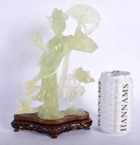 A LATE 19TH CENTURY CHINESE CARVED JADE FIGURE OF A FEMALE modelled holding a fan. 25 cm x 14 cm.