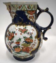 18th century Worcester mask jug painted in kakiemon style with two panels one with flowers, the