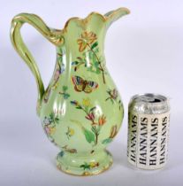 AN EARLY VICTORIAN ENAMELLED BUTTERFLY JUG. 27 cm high.