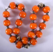 An Amber Type Bead Necklace with White Metal Mounts. Length 62cm, Bead size 20mm, weight 191g