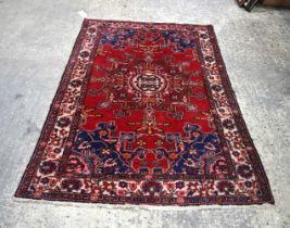 A Persian rug 185 x 127 cm.