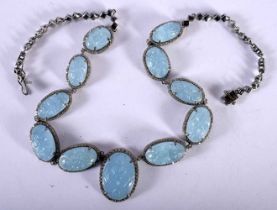 A Carved Aquamarine Bracelet with Diamond set collars. 45cm long, Largest Stone 2.7cm x 2.1cm,