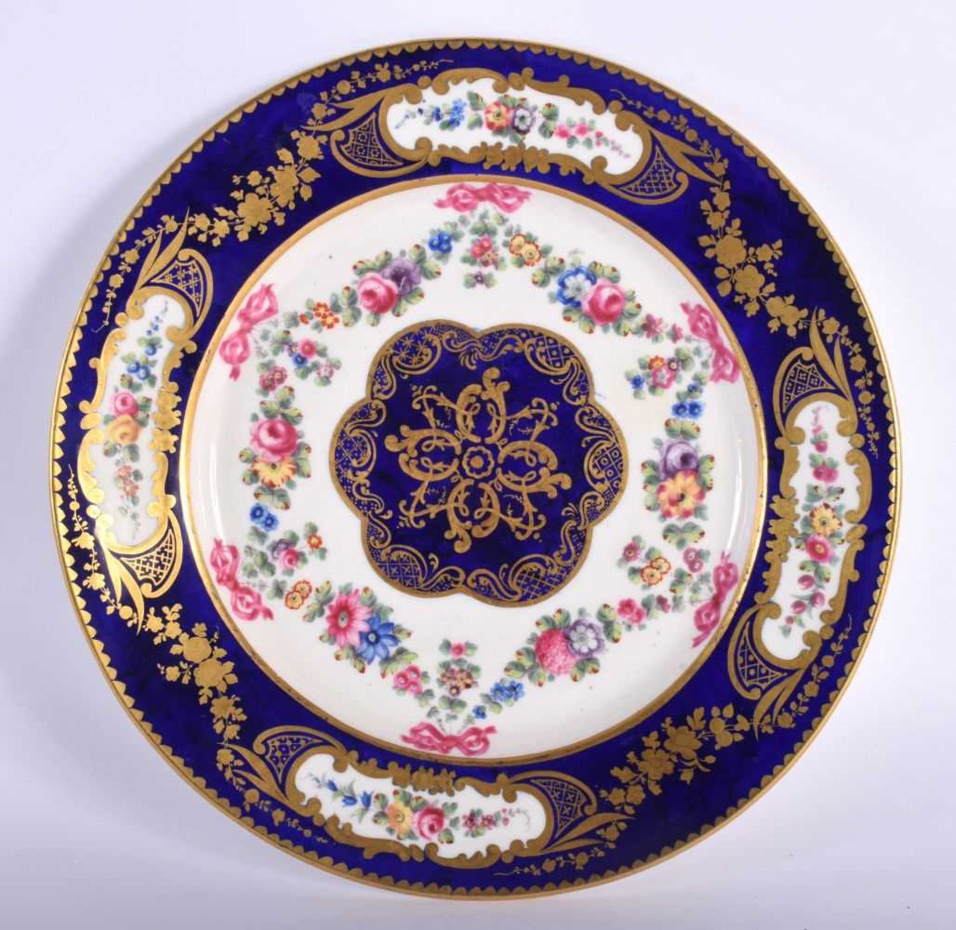 Sevres plate, the border painted in cobalt blue with four oval panels of flowers, the centre with