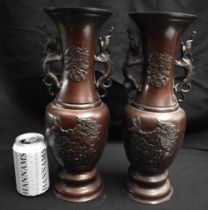 A LARGE PAIR OF 19TH CENTURY JAPANESE MEIJI PERIOD BRONZE VASES decorated with birds and foliage. 35