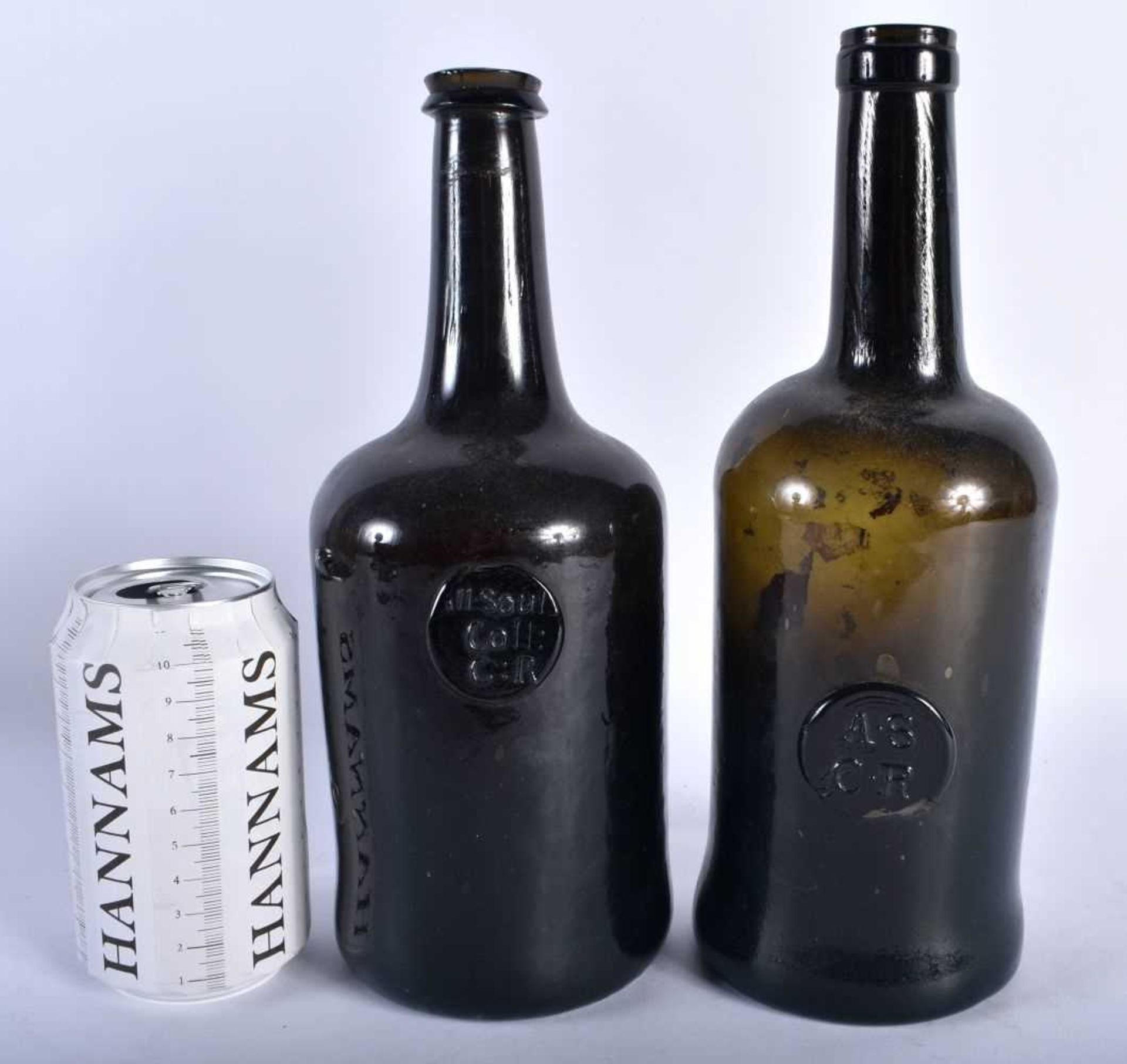 TWO 18TH CENTURY GREEN GLASS WINE BOTTLES bearing owners seal marks to the front. Largest 27 cm