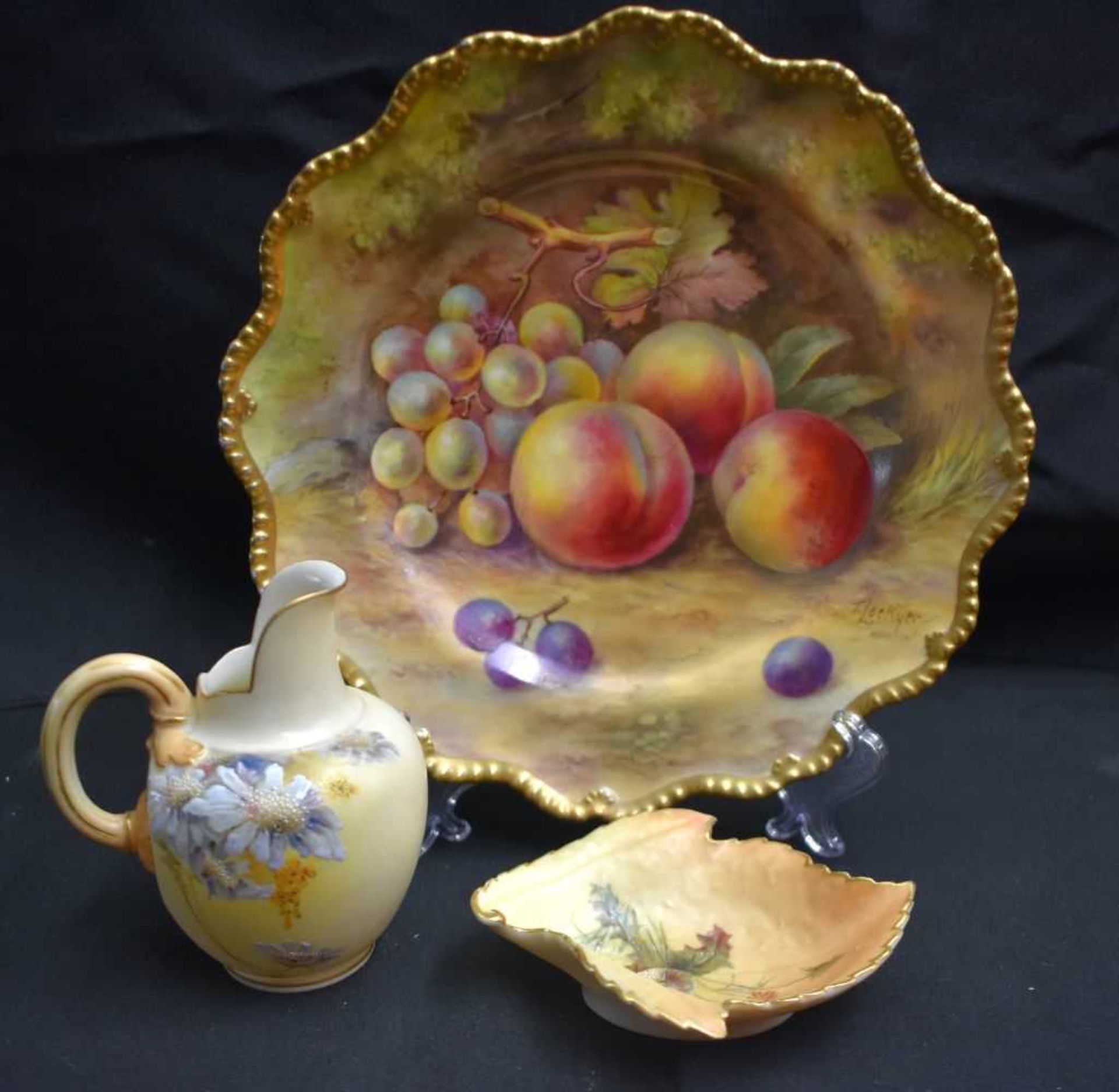A ROYAL WORCESTER FRUIT PAINTED PORCELAIN SCALLOPED PLATE by Lockyer, together with a blush ivory