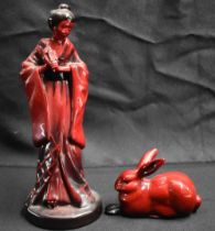 A ROYAL DOULTON FLAMBE GEISHA together with a similar rabbit. Largest 23.5 cm high. (2)