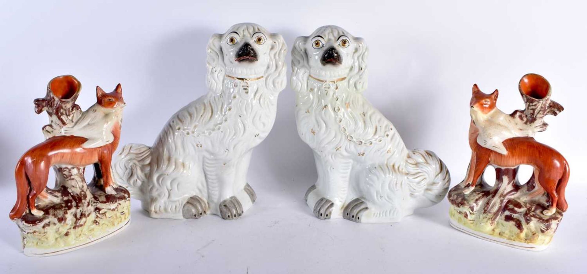 A PAIR OF 19TH CENTURY STAFFORDSHIRE FOXES together with a similar pair of spaniels. Largest 32 cm x