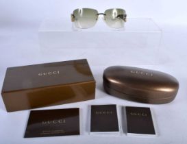 A Boxed and Cased Pair of Gucci Ladies Sunglasses. 13.8cm wide