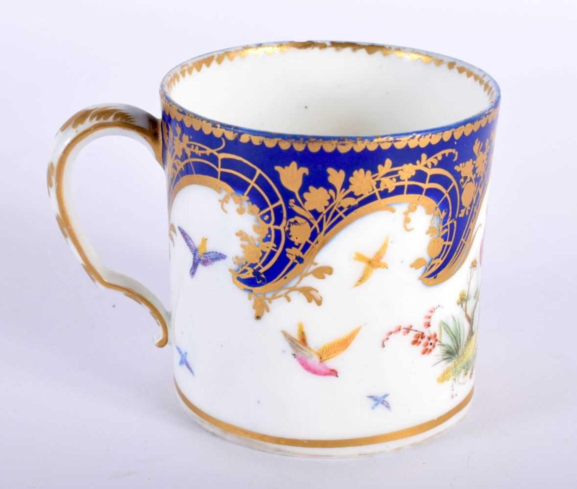 Sevres coffee can painted with two birds in landscape, flying birds and a blue and gilt cornucopia