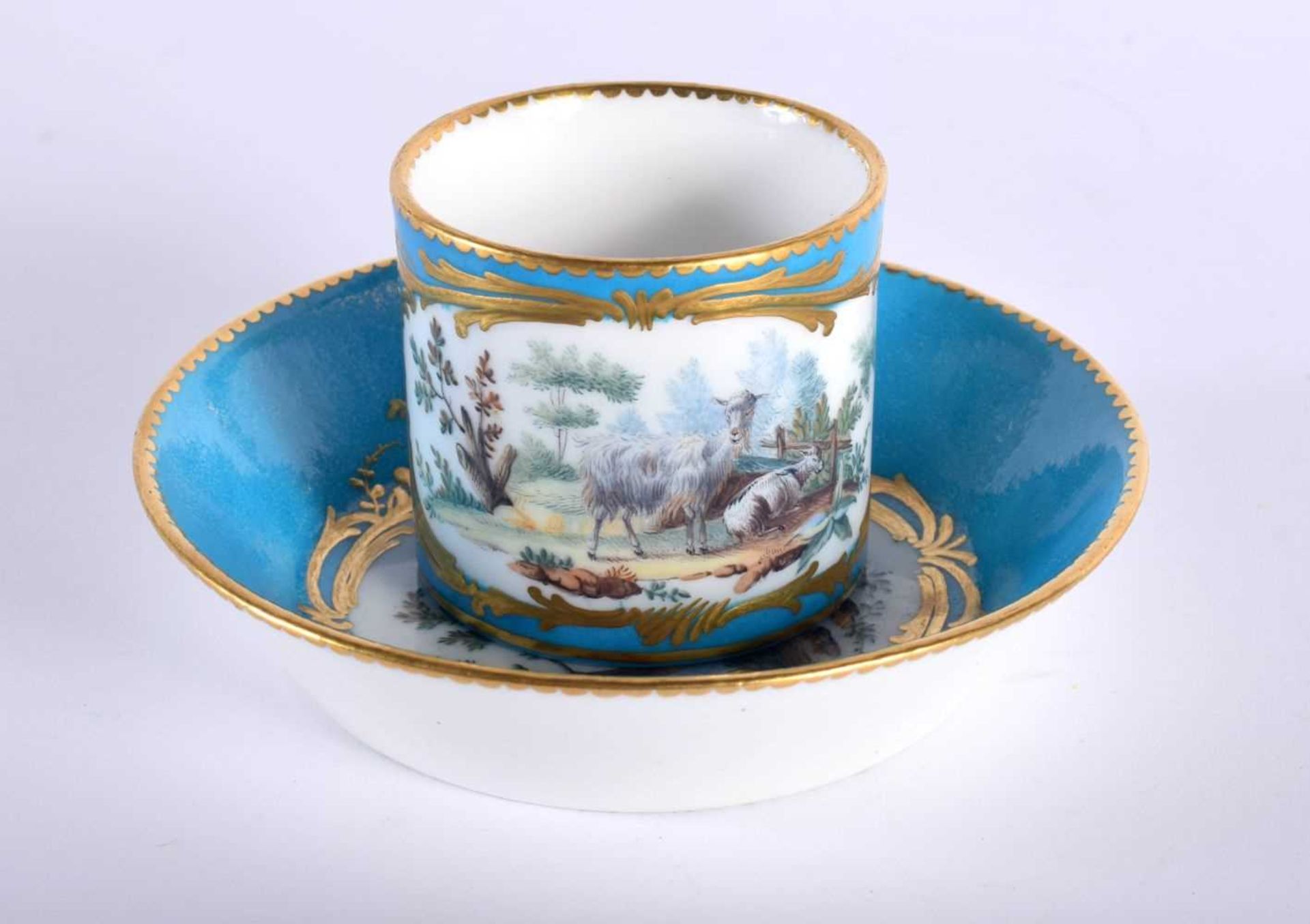 Sevres fine coffee can and saucer painted with farm animals in landscape enclosed in a gilt panel on