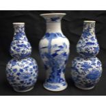 A PAIR OF 19TH CENTURY CHINESE BLUE AND WHITE PORCELAIN DOUBLE GOURD VASES Qing, together with a