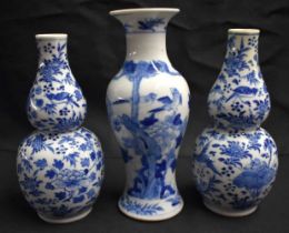 A PAIR OF 19TH CENTURY CHINESE BLUE AND WHITE PORCELAIN DOUBLE GOURD VASES Qing, together with a