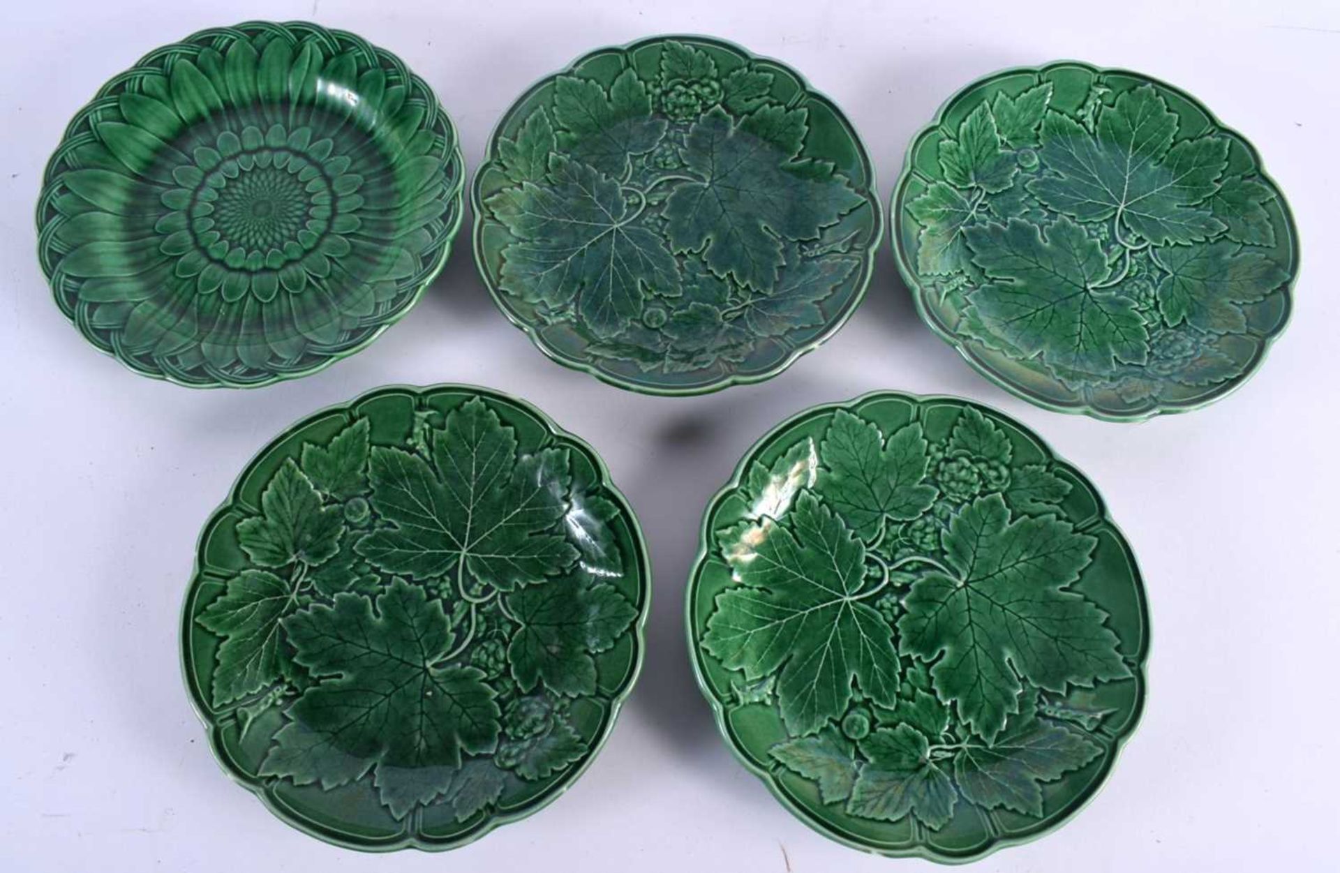 A SET OF FOUR 19TH CENTURY ENGLISH MAJOLICA CABBAGE WARE PLATES together with a similar Wedgwood