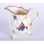 Sevres three footed cream jug painted with scattered floral sprays, no mark. 9x11cm.