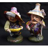 A PAIR OF ROYAL CROWN DERBY MANSIONS DWARFS. 17 cm high.