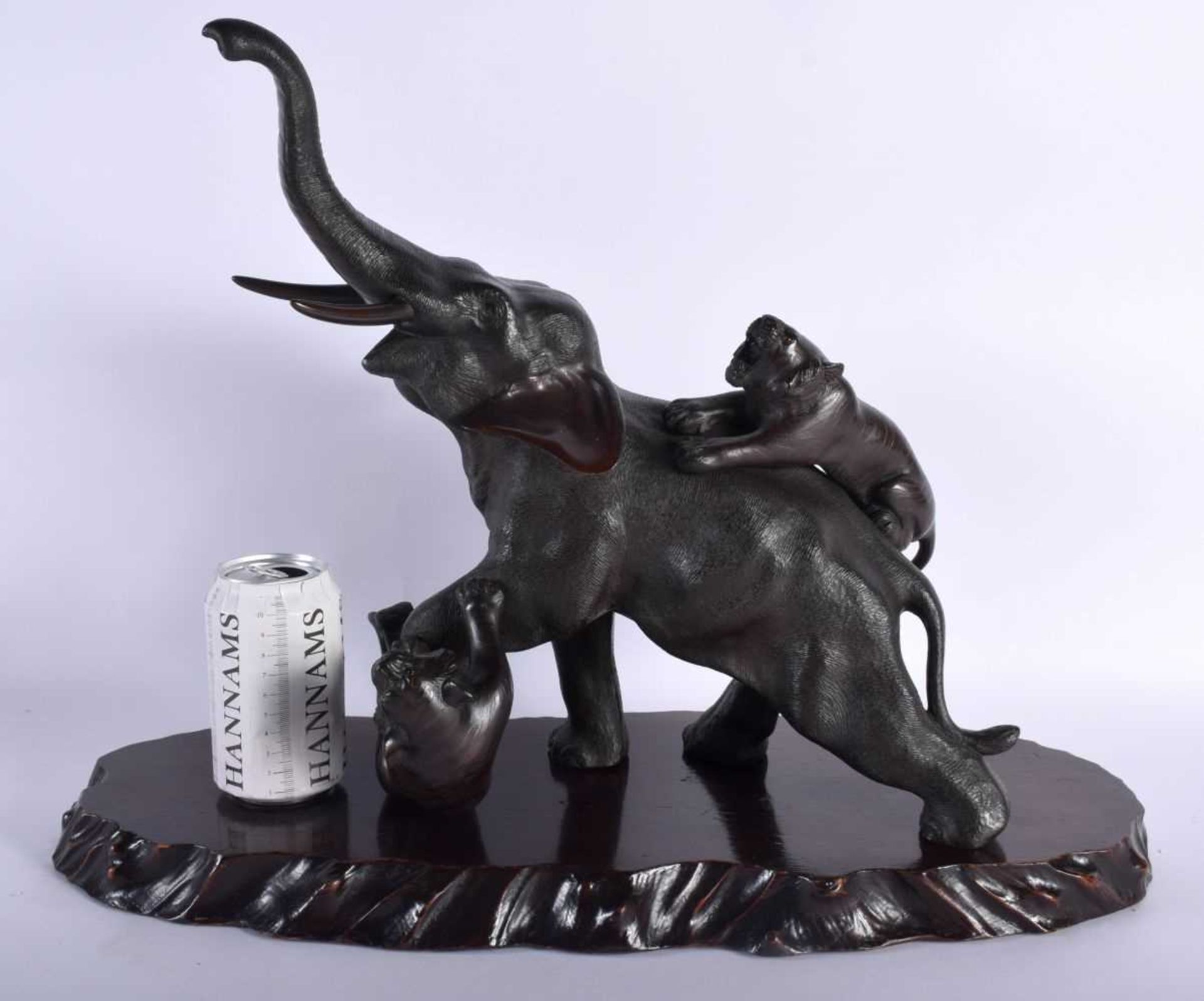 A LARGE 19TH CENTURY JAPANESE MEIJI PERIOD BRONZE OKIMONO modelled as an elephant and tiger upon a