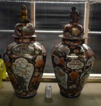 A MONUMENTAL PAIR OF 18TH CENTURY JAPANESE EDO PERIOD COUNTRY HOUSE IMARI VASES AND COVERS painted