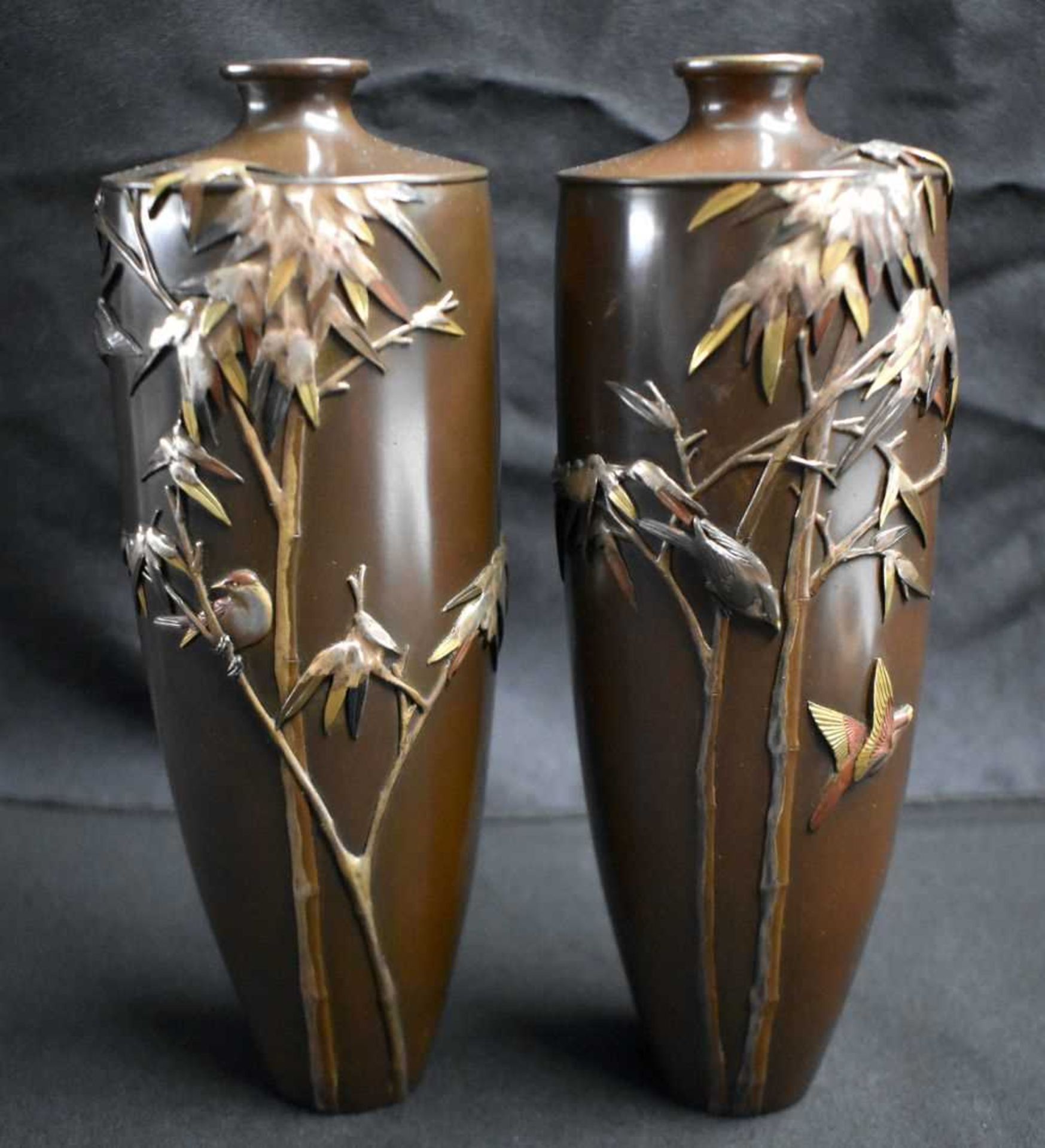 A FINE PAIR OF 19TH CENTURY JAPANESE MEIJI PERIOD BRONZE ONLAID VASES by Miyabe Atsuyoshi, depicting