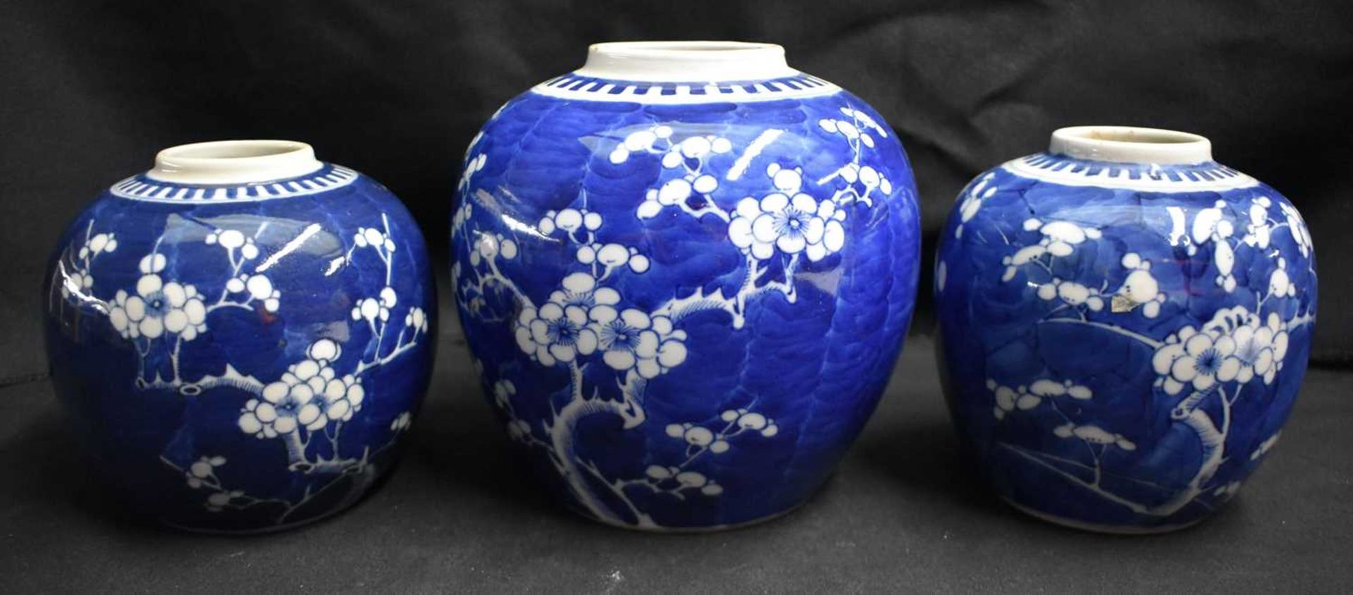 THREE 19TH CENTURY CHINESE BLUE AND WHITE PORCELAIN GINGER JARS Kangxi style. Largest 18 cm x 12 cm.