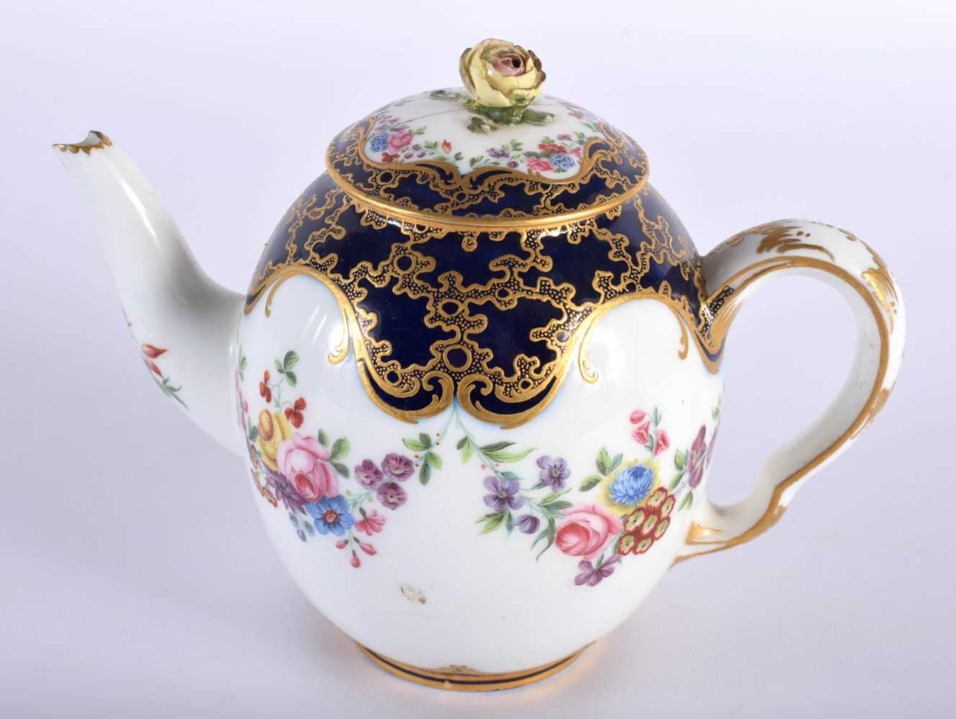 Sevres teapot and cover painted with flower swag under a blue and cracked ice gilt ground, no