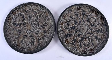 A PAIR OF 19TH CENTURY MIDDLE EASTERN SILVER OVERLAID HEAVY DISHES overlaid with fish swimming. 14.5