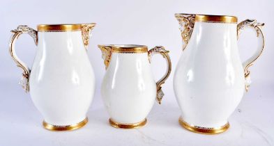 A SET OF THREE CONTINENTAL MASK HEAD JUGS. Largest 19 cm high. (3)