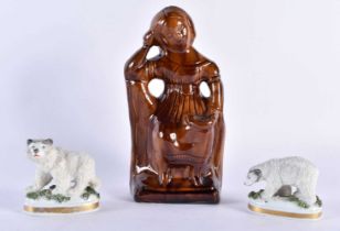 AN ANTIQUE TREACLE GLAZED FIGURAL MONEY BOX together with a pair of Continental porcelain polar