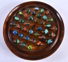 A MARBLE SOLITAIRE BOARD. 22 cm diameter.