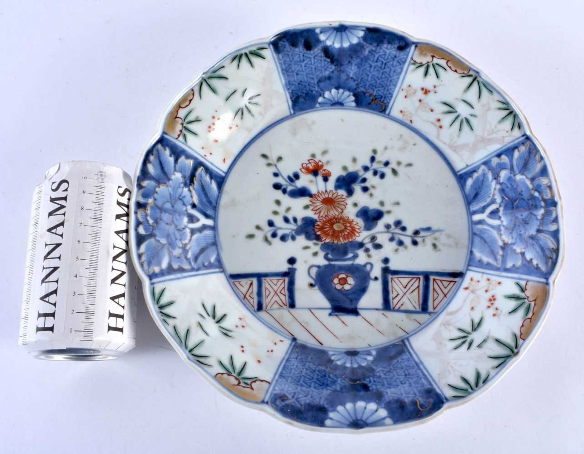 A LARGE 18TH CENTURY JAPANESE EDO PERIOD BLUE AND WHITE FLUTED DISH painted with an urn of